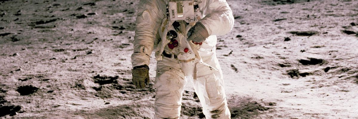 astronaut standing on gray sand