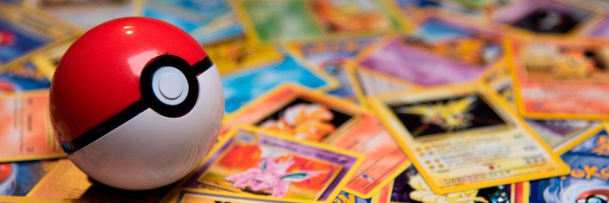 Classic Pokeball Toy on a bunch of Pokemon Cards. Zapdos, Ninetales and a Trainercard visible.