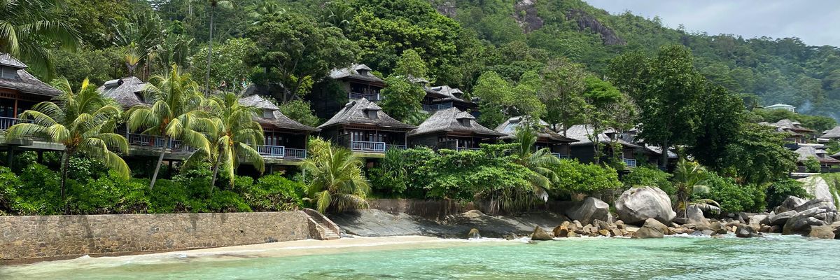 Fancy cabins and inviting beach in Victoria, Glacis, Seychelles.