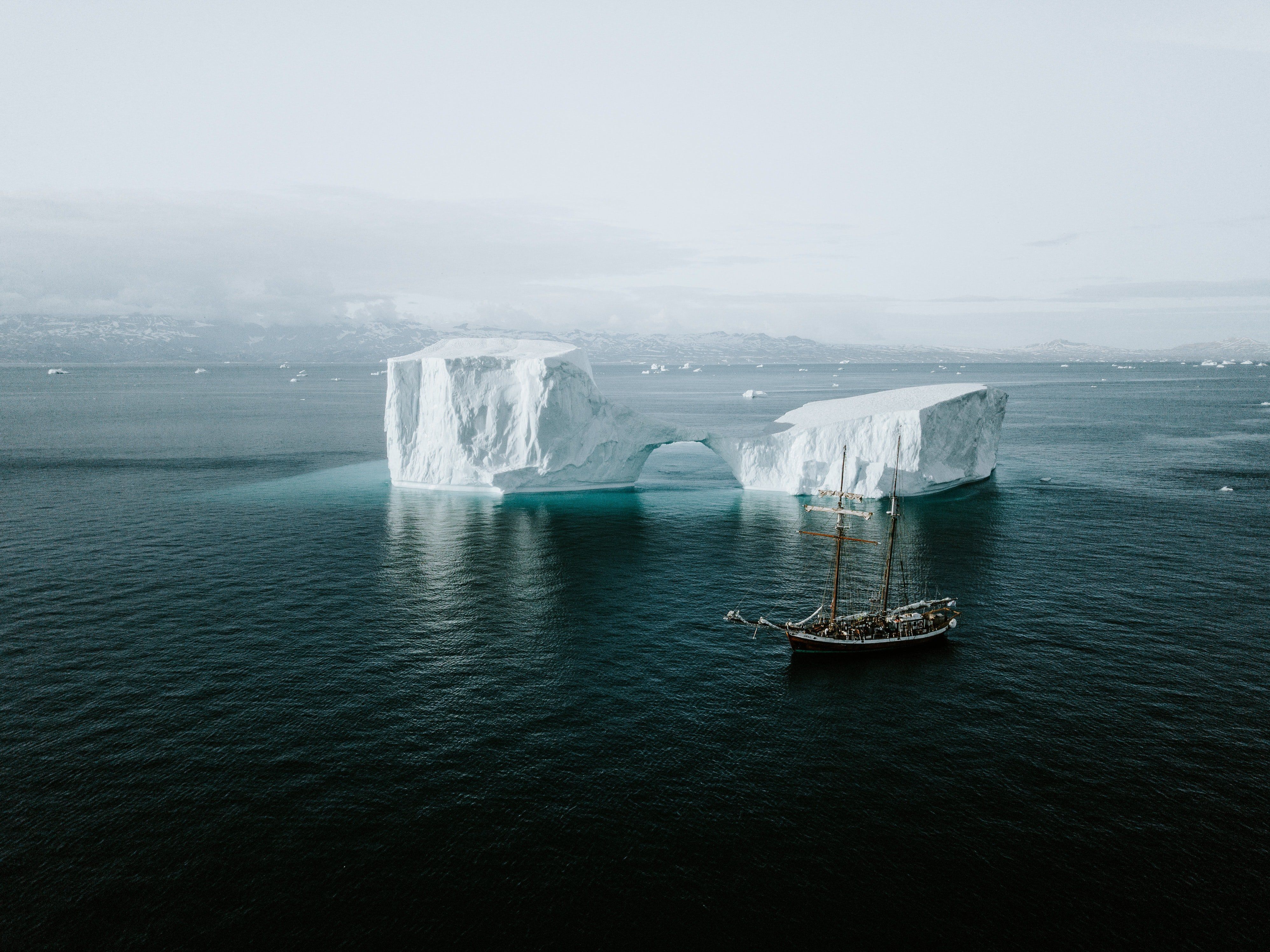 Hajó egy jéghegy mellet a Jeges-tengeren