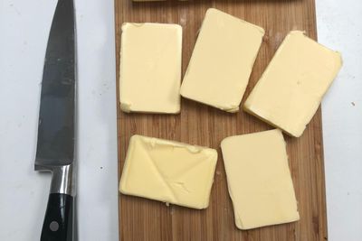 black handled knife beside cheese