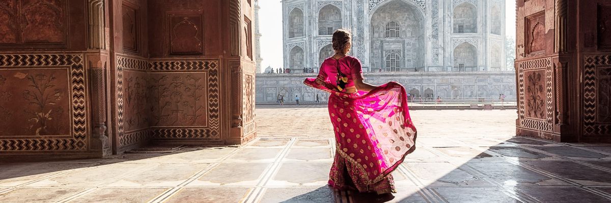 india lány áll háttal a taj mahal előtt