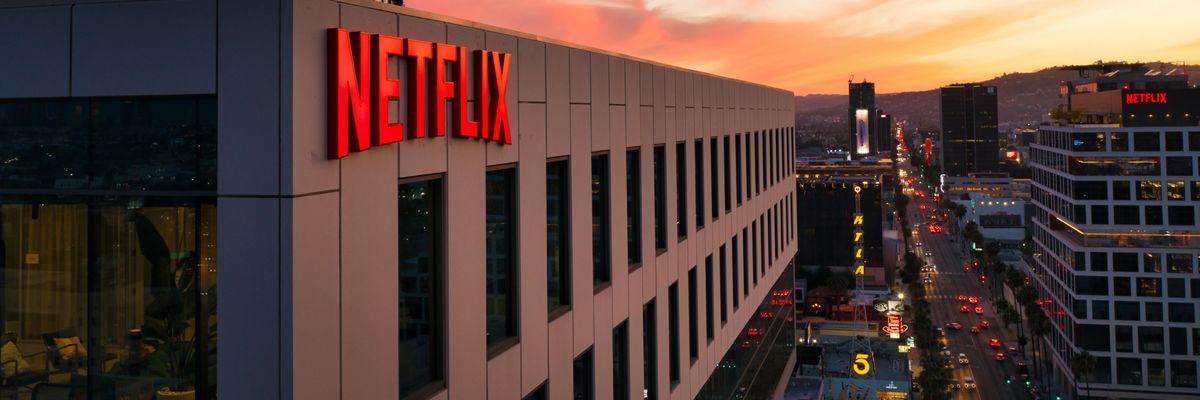 Netflix sign on a building at sunset.