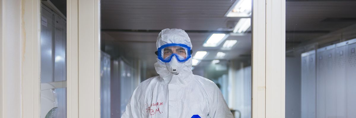 person in white jacket wearing blue goggles