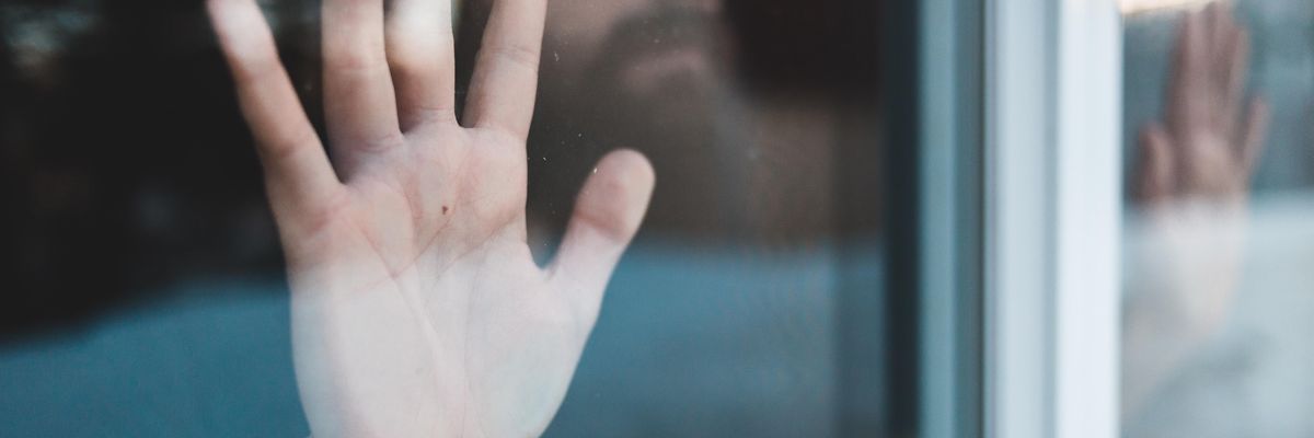 persons hand on glass window