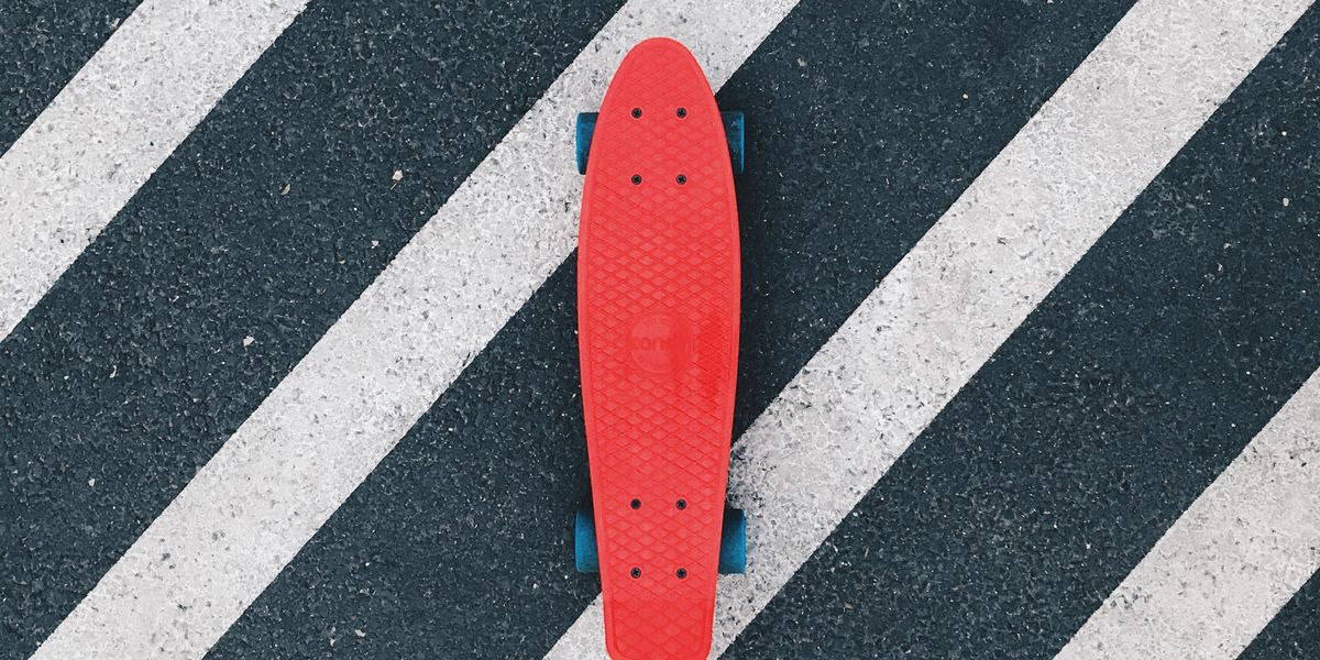 red cruiserboard on gray and white pedestrian lane