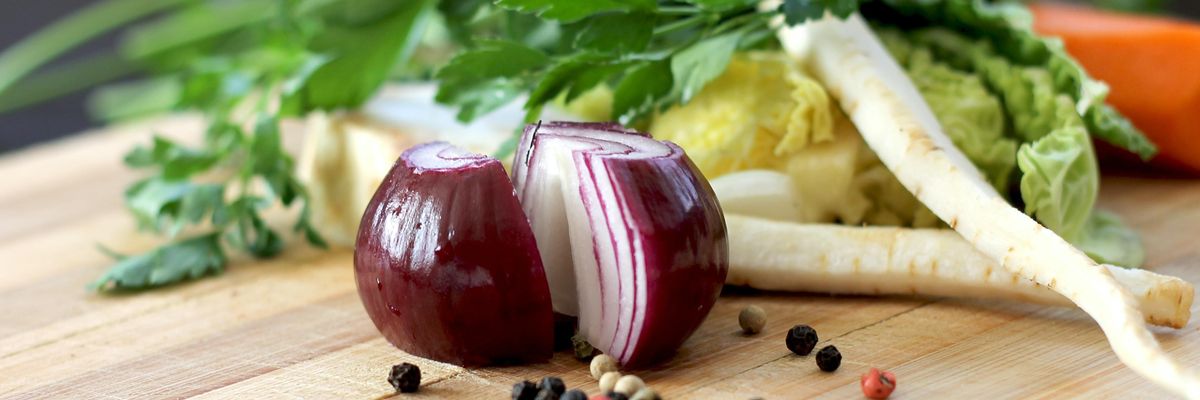 red onion on brown wooden chopping board
