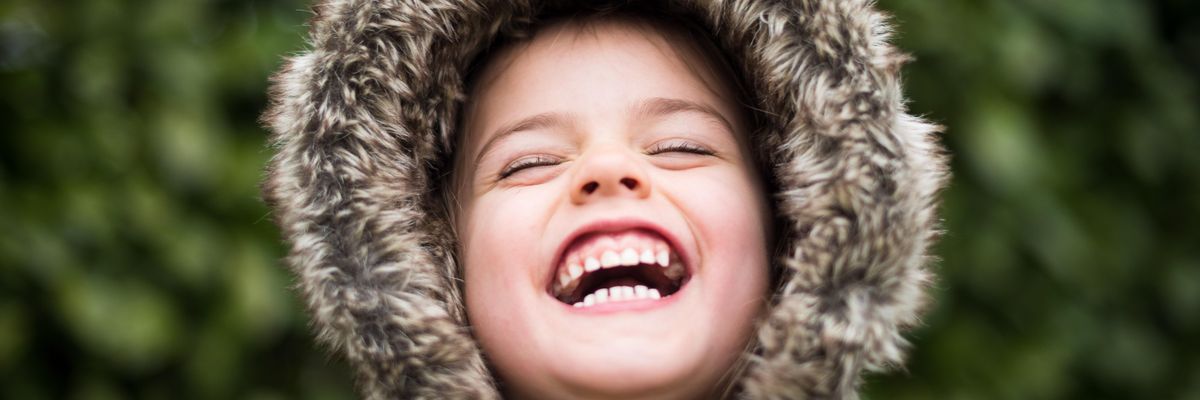 selective focus photography of child laughing
