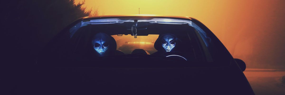 two masked person in car during night